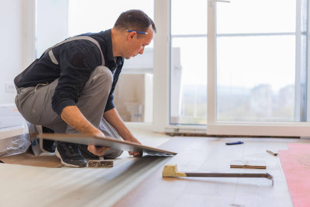 Handyman working on a new parquette floor at an apartment